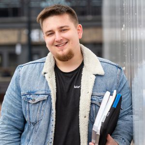 Kacper Bidniuk holding some books