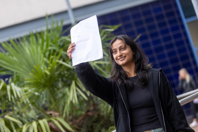 Rabina Burlakoti holding her results.