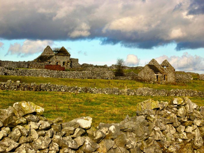 Dry stone wall and a stone building in the countryside.