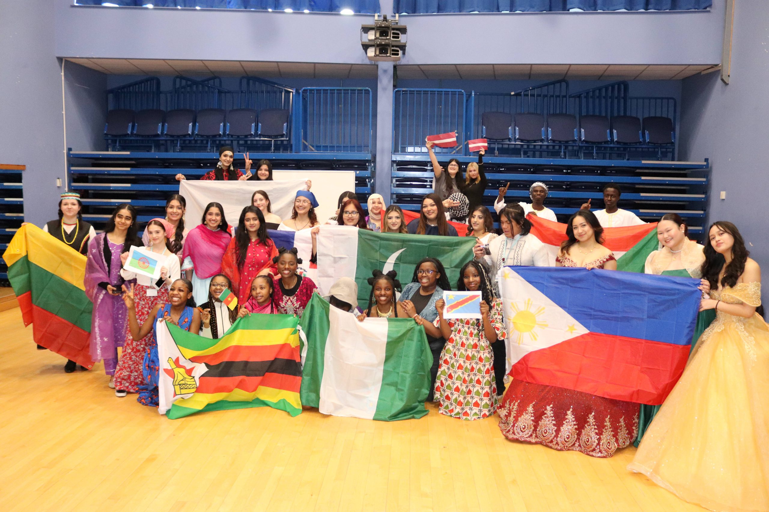 Students at the Joseph Wright Centre holding flags from different countries.