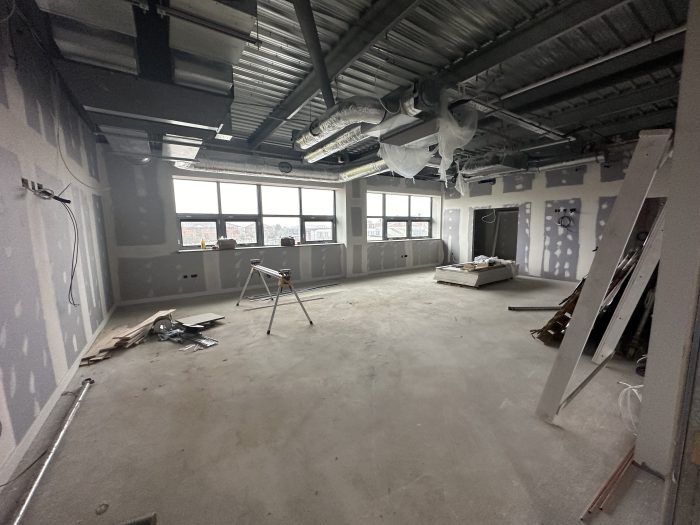 A room of the EMIoT under construction with various tools and materials.