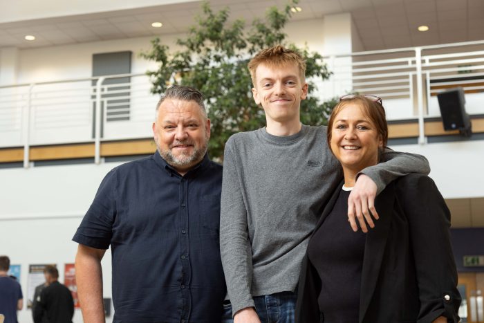 Student Lewis Smith with his parents.