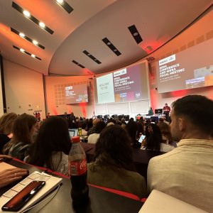 Large room with a presentation and an audience.