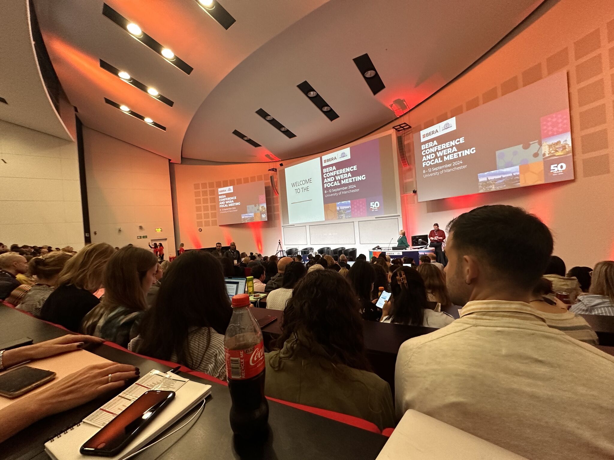 Large room with a presentation and an audience.