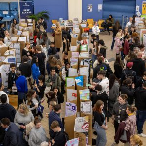 A large group of people attending a display.