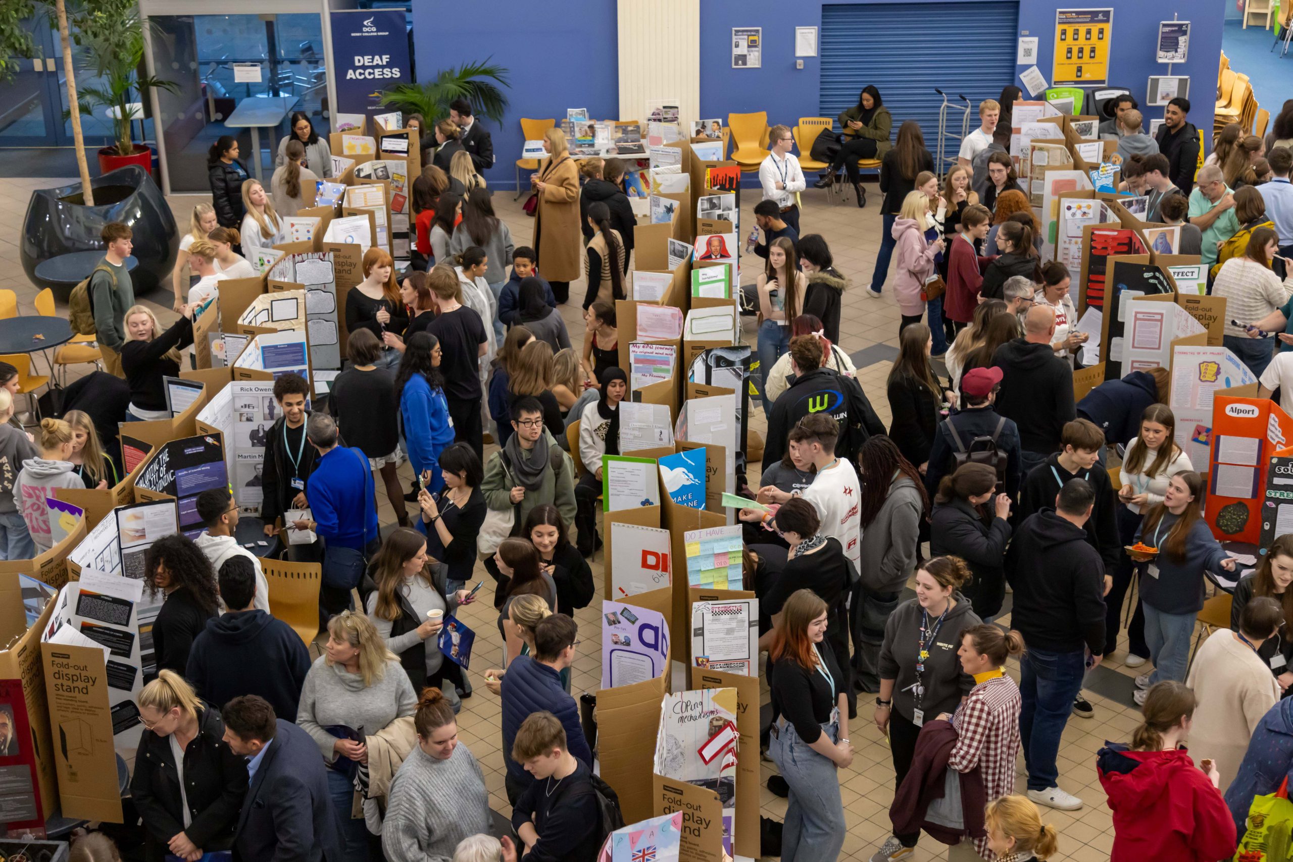 A large group of people attending a display.