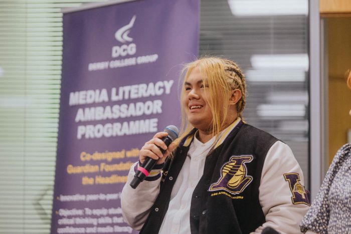 Young student talking in to a microphone.