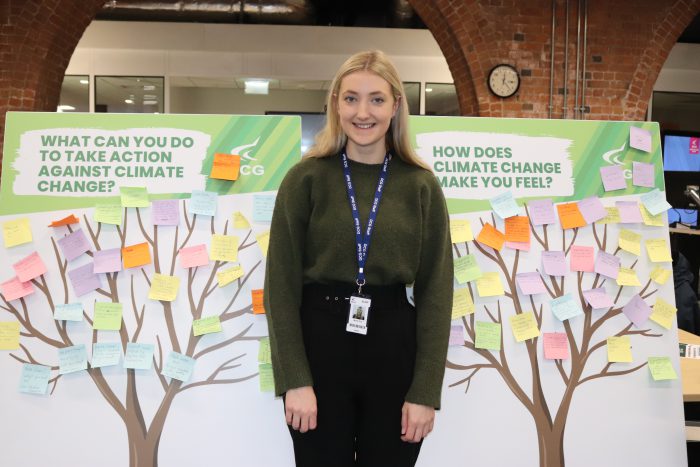 DCG Environmental & Sustainability Officer, Mollie Cox stood in front of a board with trees and post-it notes.